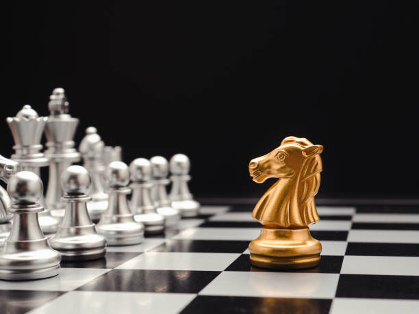istock Chess pieces on board game planning and competition on black background 1490232121