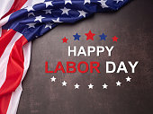 Happy labor day text over the vintage background and American Flag
