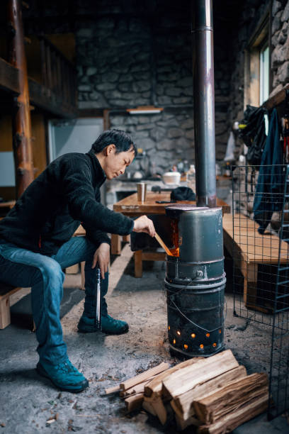 istock Mid-adult man preparing a fire in a rustic cabin 1490236714