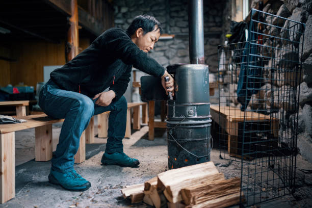 istock Mid-adult man preparing a fire in a rustic cabin 1490236782