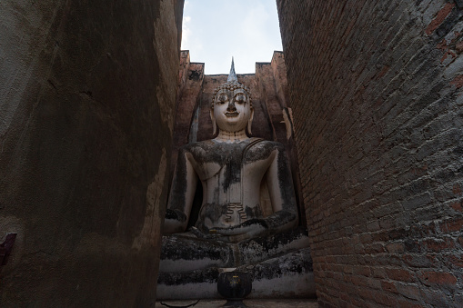 Buddha statue in Wat Si Chum temple located in the North zone of the Sukhothai Historical Park outside the walled city