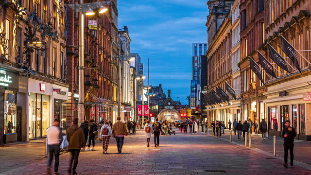 4K Footage Time lapse of Crowd people and tourist pedestrian walking and shopping at Buchanan Street and Argyle Street in city center of Glasgow at twilight time, Scotland