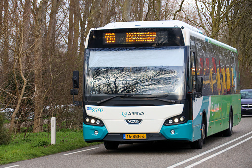 White green bus of Arriva between Rotterdam and Gouda in NIeuwerkerk in the Netherlands