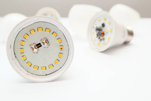 istock Disassembled LED lamp with one light emitting diode chip burnt out. Broken led bulb on a white. Modern lighting under repair. 1490247455
