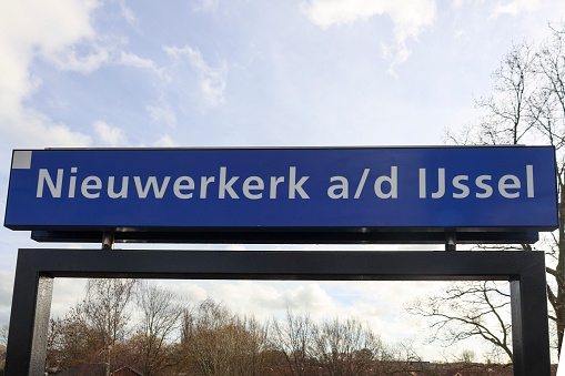 Name sign Nieuwerkerk a/d IJssel at the railroad station in this village in the Netherlands