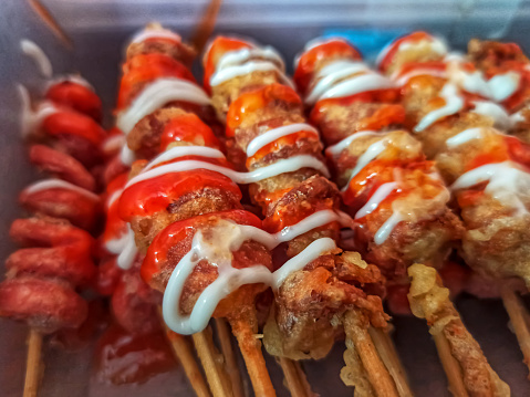 The street food made of cut and skewered sausages. It is coated in batter, deep-fried, and served with mayonnaise.