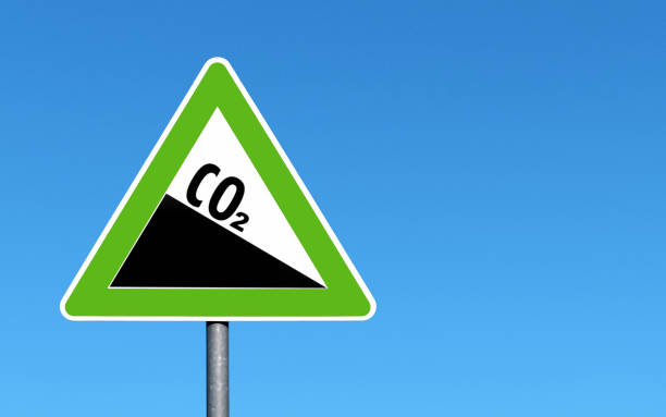 istock CO2 emission reduction sign green triangular shape against a clear blue sky 1490250112