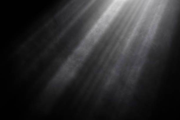 istock Light beams and smoke against black background 1490250359