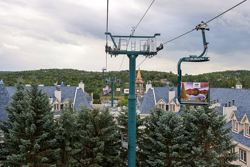 Mont Tremblant, Quebec, Canada - Aug 31, 2022: A lift ride over the rooftops in the village of the Mont Tremblant Ski Resort in summer