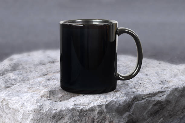 istock Glossy 11 oz. Black Mug Mockup in Rugged Outdoor Scene 1490253115