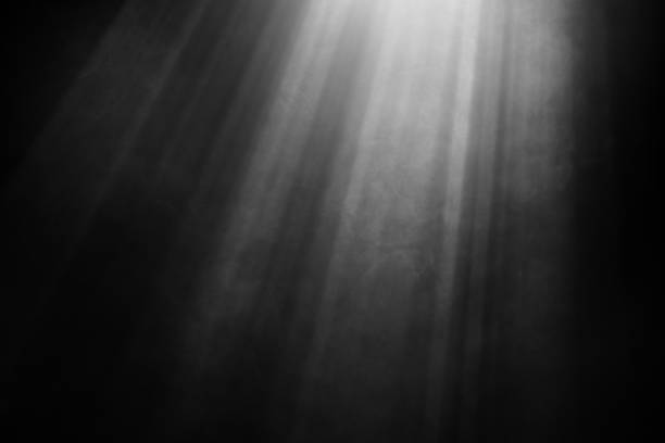istock Light beams and smoke against black background 1490253589