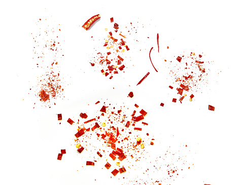 Red chilli flakes, Hot crushed red cayenne pepper flakes scattered over white background.dried chili flakes and seeds