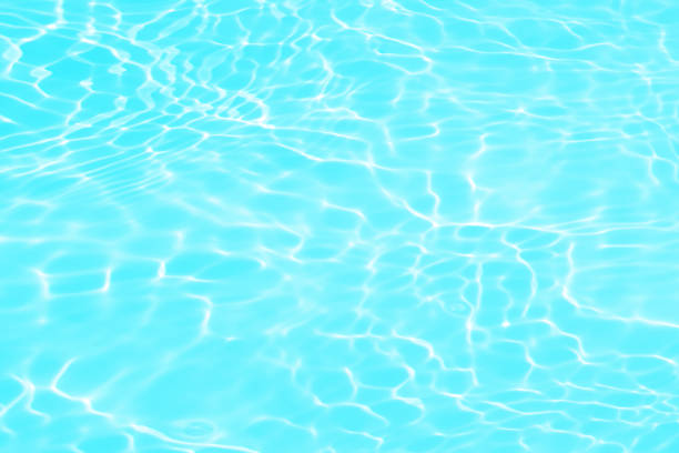 istock Blue water with ripples on the surface. Defocus blurred transparent blue colored clear calm water surface texture with splashes and bubbles. Water waves with shining pattern texture background. 1490257622