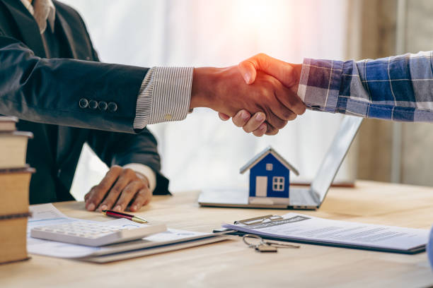 istock Successful handshake and agreement Real estate agent and client celebrating contracts completed after signing on home insurance and investment loans. house sale ideas 1490258058
