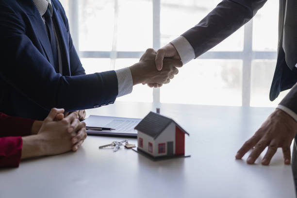 istock Successful handshake and agreement Real estate agent and client celebrating contracts completed after signing on home insurance and investment loans. house sale ideas 1490258102