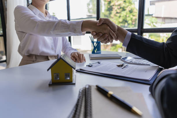 istock Successful handshake and agreement Real estate agent and client celebrating contracts completed after signing on home insurance and investment loans. house sale ideas 1490258143