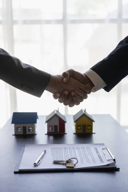 istock Successful handshake and agreement Real estate agent and client celebrating contracts completed after signing on home insurance and investment loans. house sale ideas 1490258175