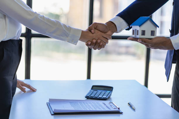 istock Successful handshake and agreement Real estate agent and client celebrating contracts completed after signing on home insurance and investment loans. house sale ideas 1490258272