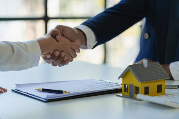 istock Successful handshake and agreement Real estate agent and client celebrating contracts completed after signing on home insurance and investment loans. house sale ideas 1490258277