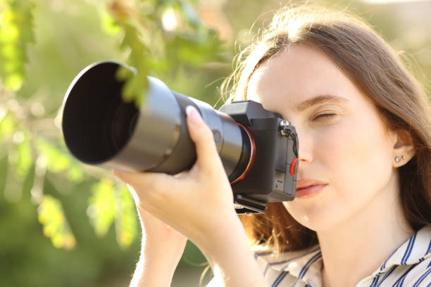 istock Photographer taking photos with a mirrorless camera 1490263947