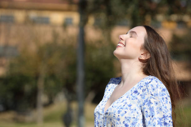 istock Happy woman breathing in a park 1490264061