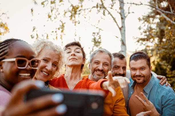 istock Diverse mature happy people making selfie in the park 1490265874
