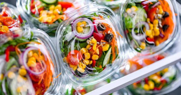 istock Boxes with pre-packaged vegetable salads in a commercial fridge 1490267726