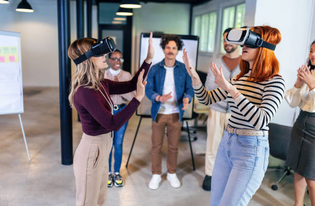 istock Business people making team training exercise during team building seminar using VR glasses 1490268162