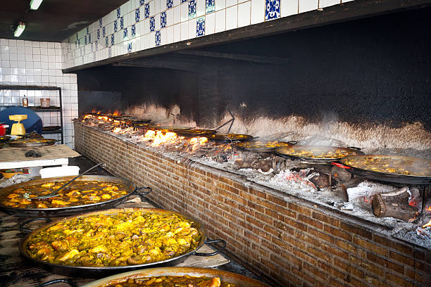 istock Valencian paella cooking on log fire 149026945