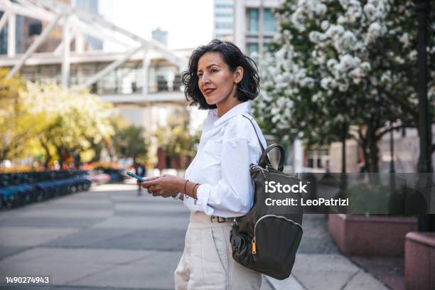 Businesswoman Busy On Mobile Phone Out Of The Office While Waiting For The Bus Stock Photo - Download Image Now