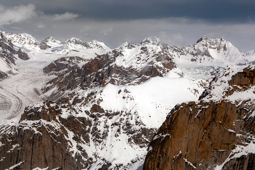 panorama view of winter mountain landscape in the Swiss Alps near Klosters with a large glacier in the foreground