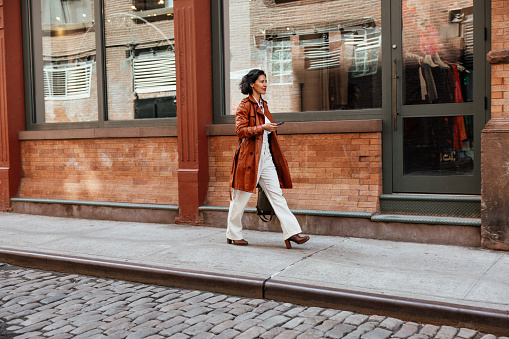 Morning in New York, a hispanic business person walks to the office.