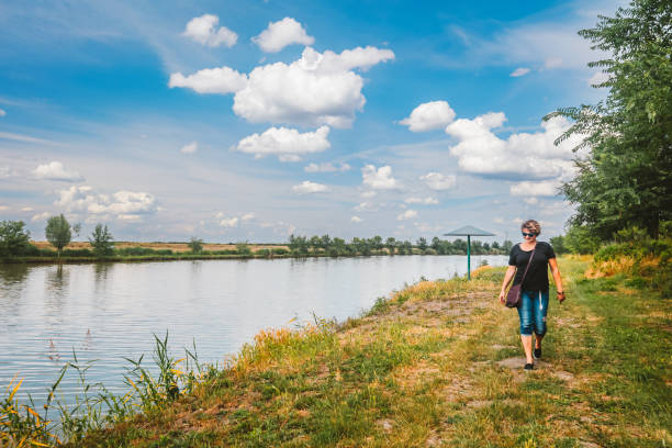 istock Woman taking a walk down the riverbank on a fine spring day 1490276006