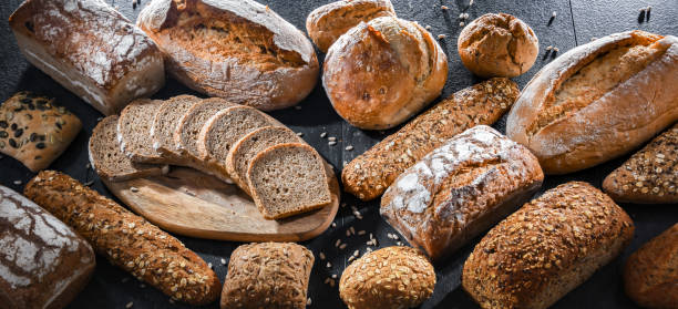 istock Assorted bakery products including loaves of bread and rolls 1490277373