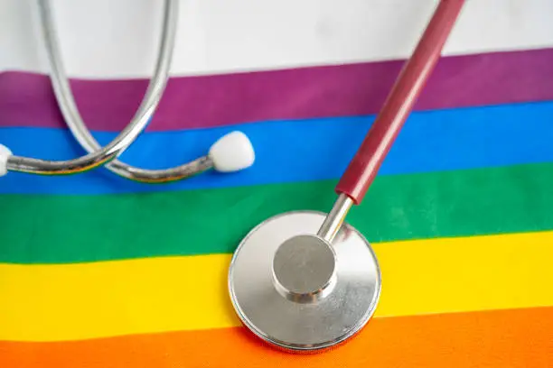 Red stethoscope on rainbow flag background, symbol of LGBT pride month  celebrate annual in June social, symbol of gay, lesbian, bisexual, transgender, human rights and peace.