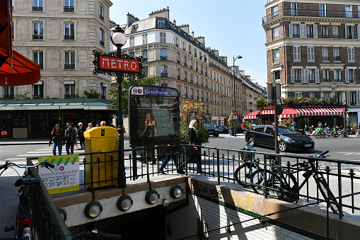 Paris, France-05 14 2023: People walking down  the rue de Rennes and the Saint-Placide subway entrance in Paris, France.