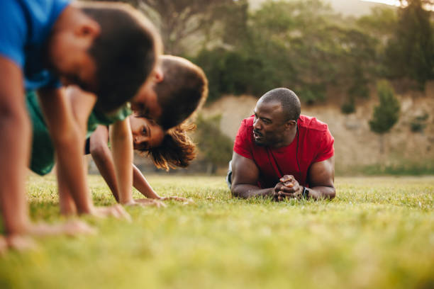 istock Sports coach training a school team in a rugby field 1490280830