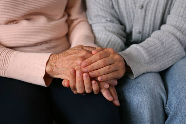istock Older age mother and her daughter holding hands. 1490282030