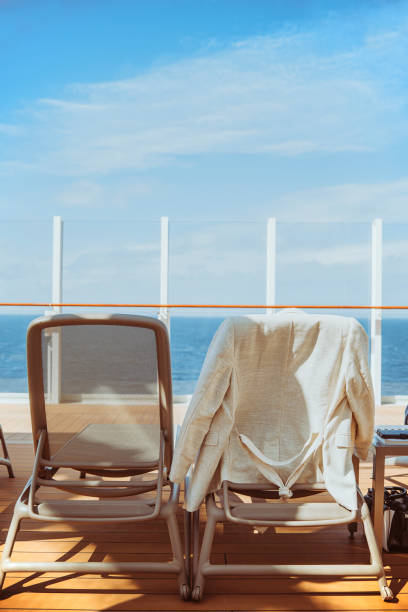 istock Two empty sunbeds and a beige linen blazer on a cruise ship deck on a sunny day. 1490288931