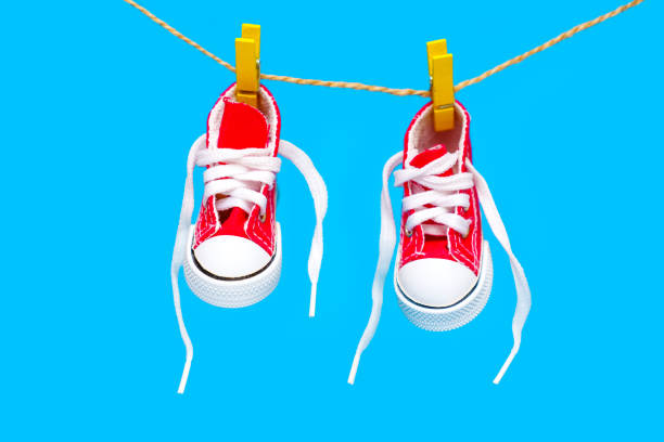 istock Tiny Red High-Top Canvas Shoes on a Clothesline 1490290922