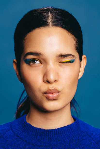 istock Female with bold eyeliner making a face, winking and pouting her lips 1490291603