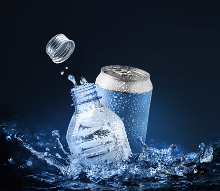Drinking and mineral water in plastic bottle and aluminum can with splash around on blue background