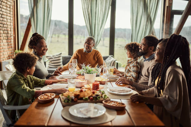 istock Happy black extended family talking during lunch at dining table. 1490292803