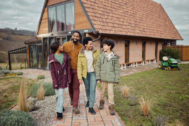 istock Carefree black family taking a walk in the front yard. 1490293404
