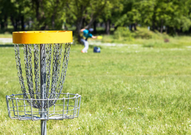 Disc golf player playing flying disc sport game in the nature stock photo