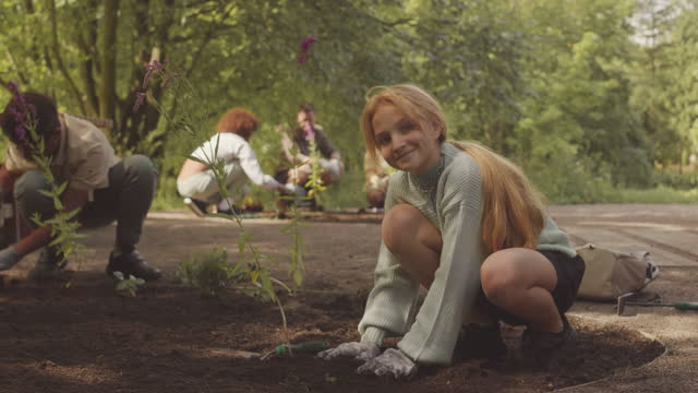 Portrait of Volunteer Girl Planting in Public Park