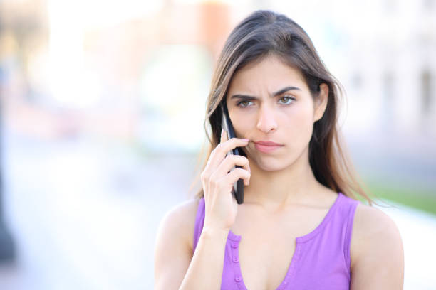 istock Suspicious woman attending phone call 1490293698