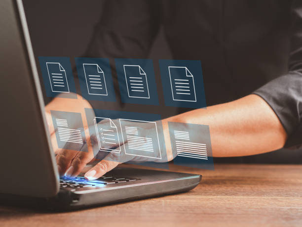 istock Businessman working at a laptop and digital documents with checkbox lists on virtual screen. 1490294771