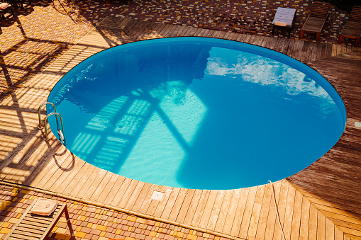 A round kids pool in family-friendly hotels. It is a shallow pool designed for children to play in and is typically supervised by lifeguards.