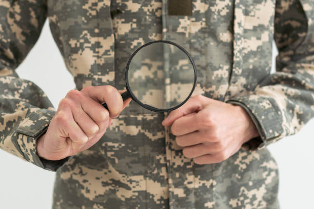 istock soldier holding magnifying glass in office 1490295536